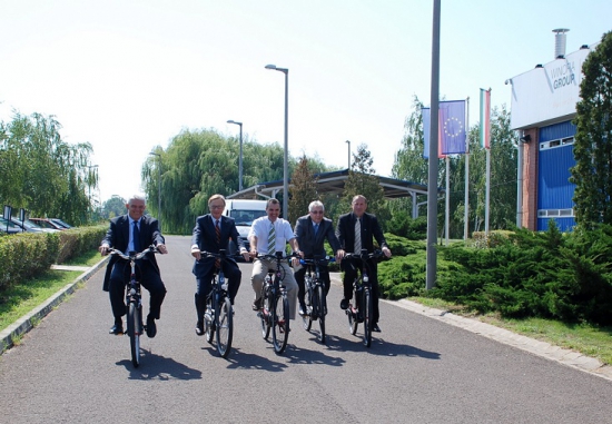 A képen Szalay József, Szolnok polgármestere, Gajus Scheltema, holland nagykövet, Dr. Gyuricza Miklós, Tószeg polgármestere, Dr. Papp Antal, Martfű polgármestere és Steurer Zsolt, a gyár igazgatója ülnek az elektromos járműveken